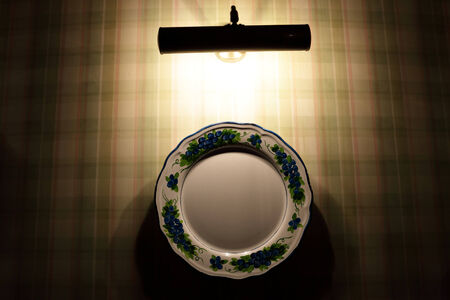 Decorative plate on the wall at nightの写真素材