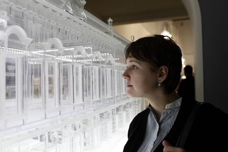 Woman looking at model building in the museum