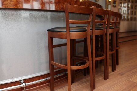Details of the wooden bar stools in a restaurantの写真素材