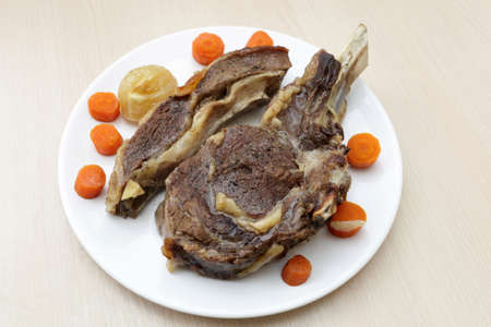 Baked beef on a plate with vegetables