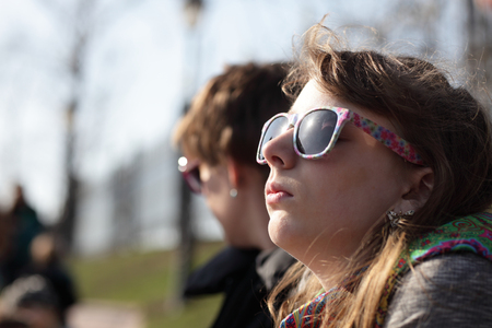 Girl sunbathes in the park in springの写真素材
