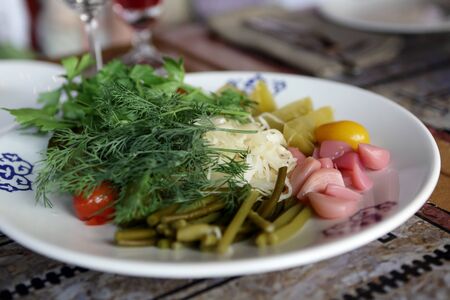 Pickled vegetables on a plate in the restaurantの写真素材