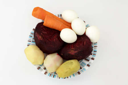 Plate with various boiled vegetables on the tableの写真素材