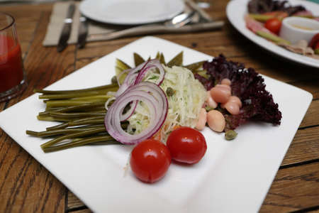 Pickles on the white plate in the restaurantの写真素材