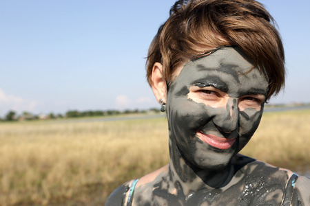 Portrait of a woman with mud face