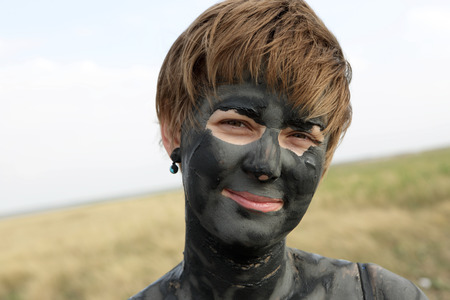 Woman with healthy mud on her faceの写真素材