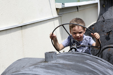 Child driving an old tractor in the museumの写真素材