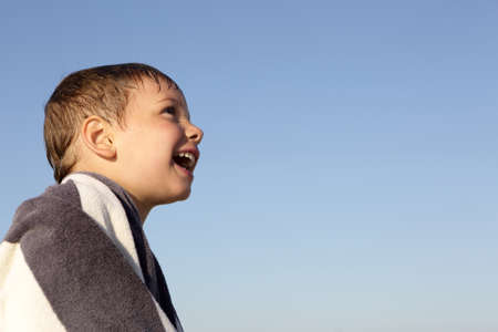 Portrait of a happy boy on a sky backgroundの写真素材
