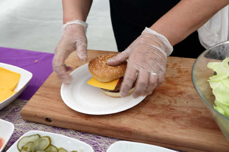 Chef cooking burgers in the outdoor restaurantの写真素材