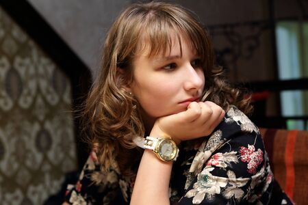 Portrait of a thinking teen in the restaurant