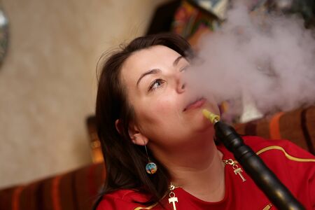 Woman smoking shisha in the arabic cafe