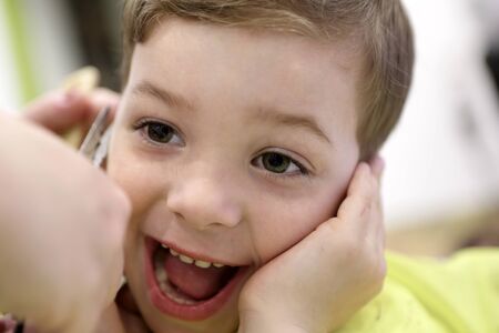 Portrait of laughing boy at the barbershop