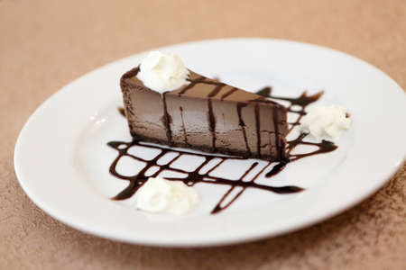 Chocolate cheesecake on plate in a cafeの写真素材