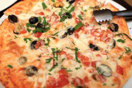 Seafood pizza on a plate in restaurantの写真素材