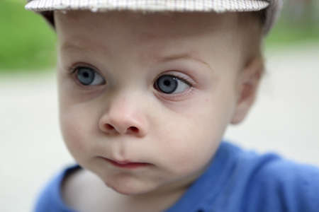 Portrait of a serious child in summer parkの写真素材