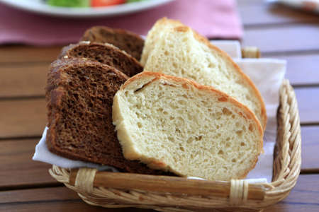 Basket with white and dark bread in a restaurant