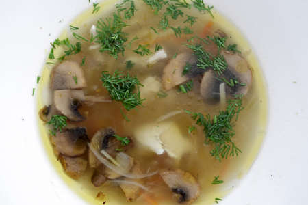 White plate with mushroom soup in a restaurantの写真素材