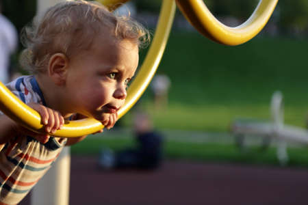 Toddler climbing ring obstacle at an outdoor playground