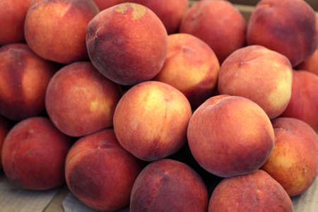 Peaches in box on the counter in marketの写真素材