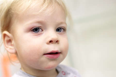 Face of a thinking toddler at home