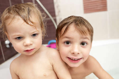 Two brothers playing at bathroom at homeの写真素材