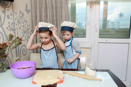 Two Boys Cooking dumplings in kitchen at homeの写真素材