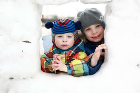 Portrait of two children in snow house