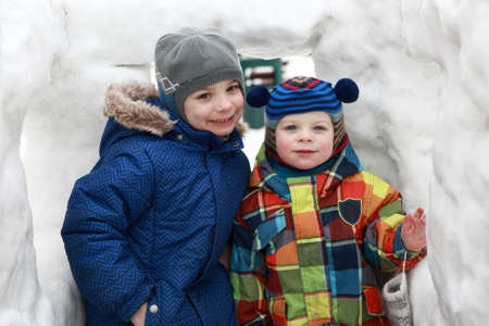 Portrait of two brothers in snow houseの写真素材