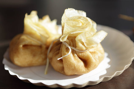 Two stuffed pancakes on a white plateの写真素材