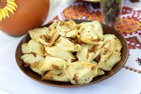 Vareniki with roasted onions on a plateの写真素材