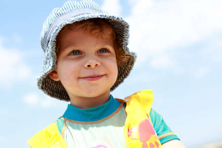Portrait of smiling boy on sky background