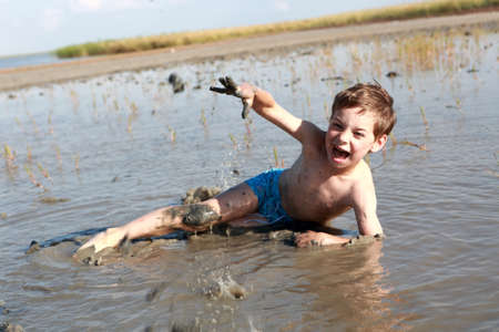 Boy is lying in healing mud, Russia