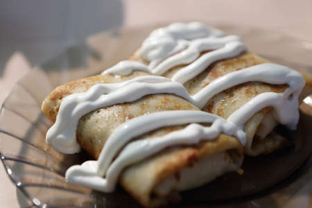 Pancakes with sour cream on a plate
