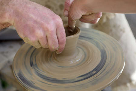 The potter teaching a kid making pottery
