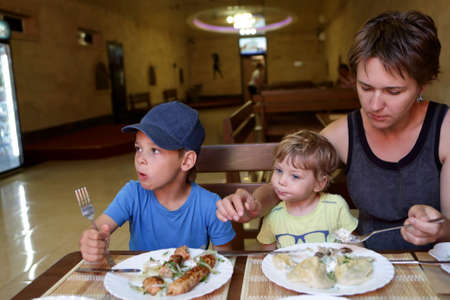 Mother with her sons have lunch in an asian restaurantの写真素材