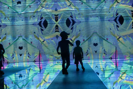 Silhouette of children in a kaleidoscope tunnel