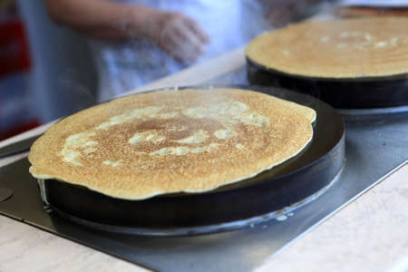 Cooking of pancakes on a street of townの写真素材