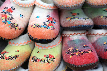 Felt shoes with embroidery on a counterの写真素材