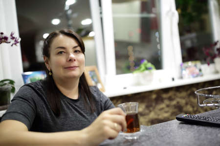 Woman with cup of tea at homeの写真素材