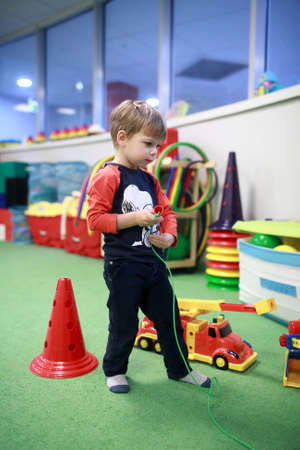 Portrait of boy playing in a game roomの写真素材