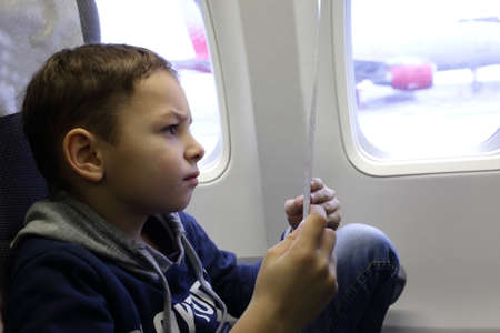 Child reading safety instructions in an arcraft