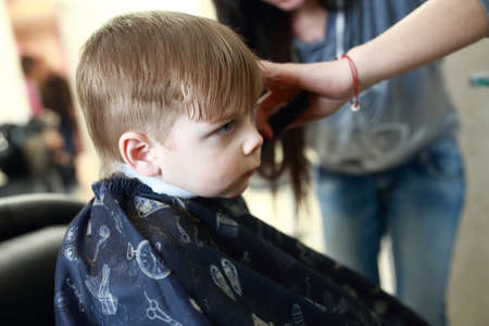 Portrait of a child getting a haircutの写真素材