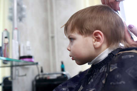 Portrait of a child in hairdressing salonの写真素材