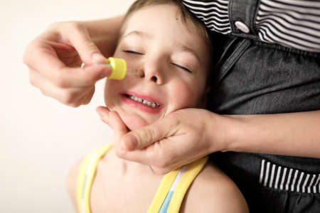 Treatment of a kid cold at homeの写真素材