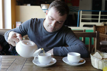 Man pouring green tea in a restaurant