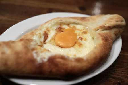 Adjarian Khachapuri on plate in a restaurant