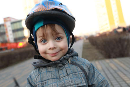 Portrait of smiling child with crash helmet in springの写真素材