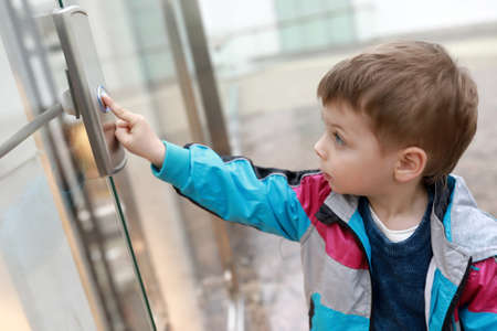 Portrait of child in front of elevatorの写真素材