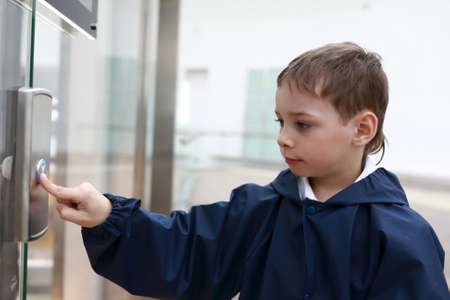 Portrait of kid in front of elevator