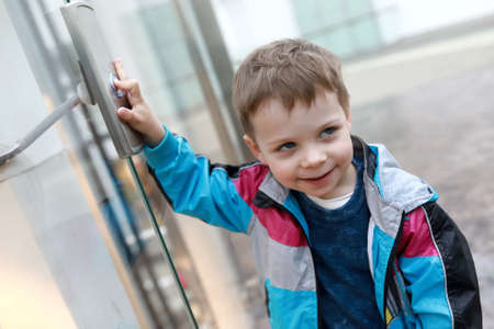 Portrait of boy in front of elevator